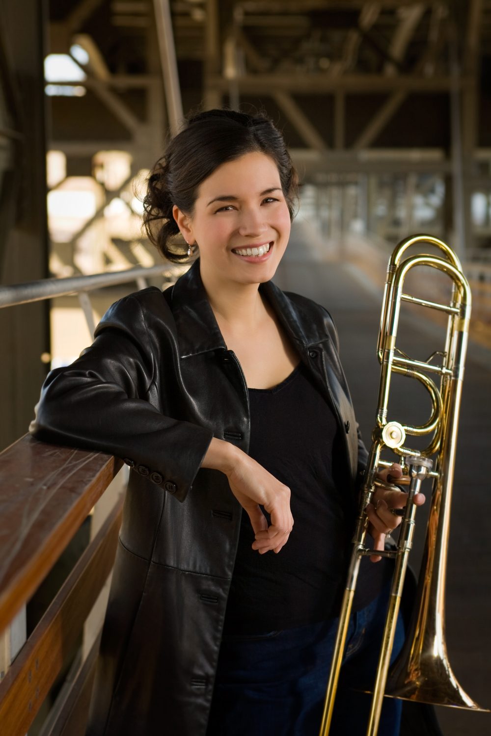 Megumi Kanda smiling and holding her trombone