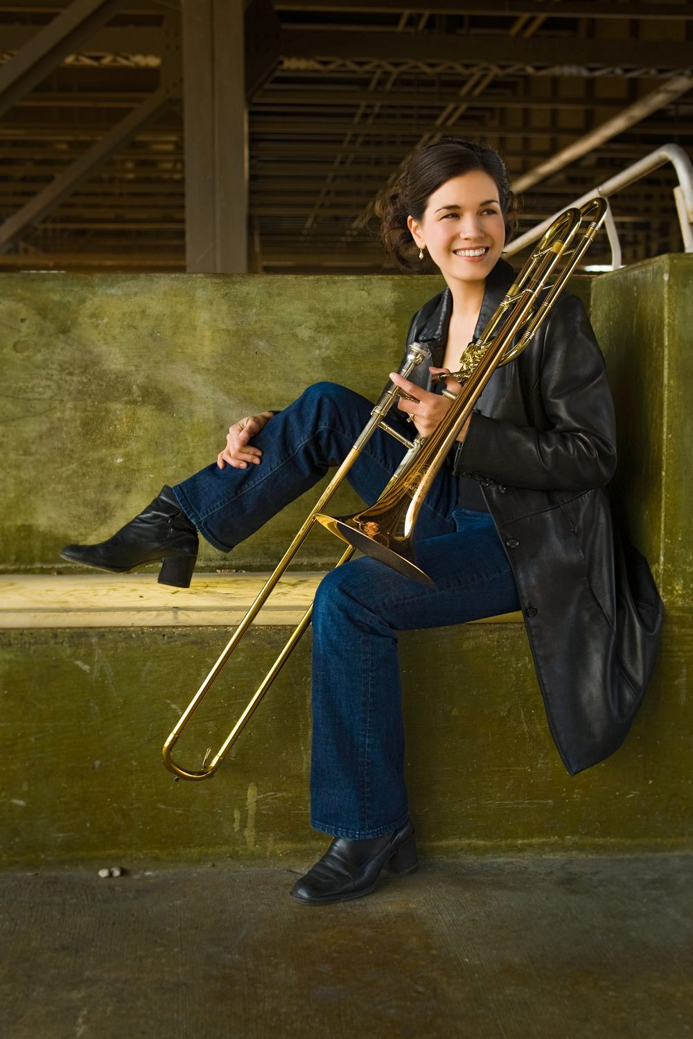 Megumi Kanda seated with her trombone