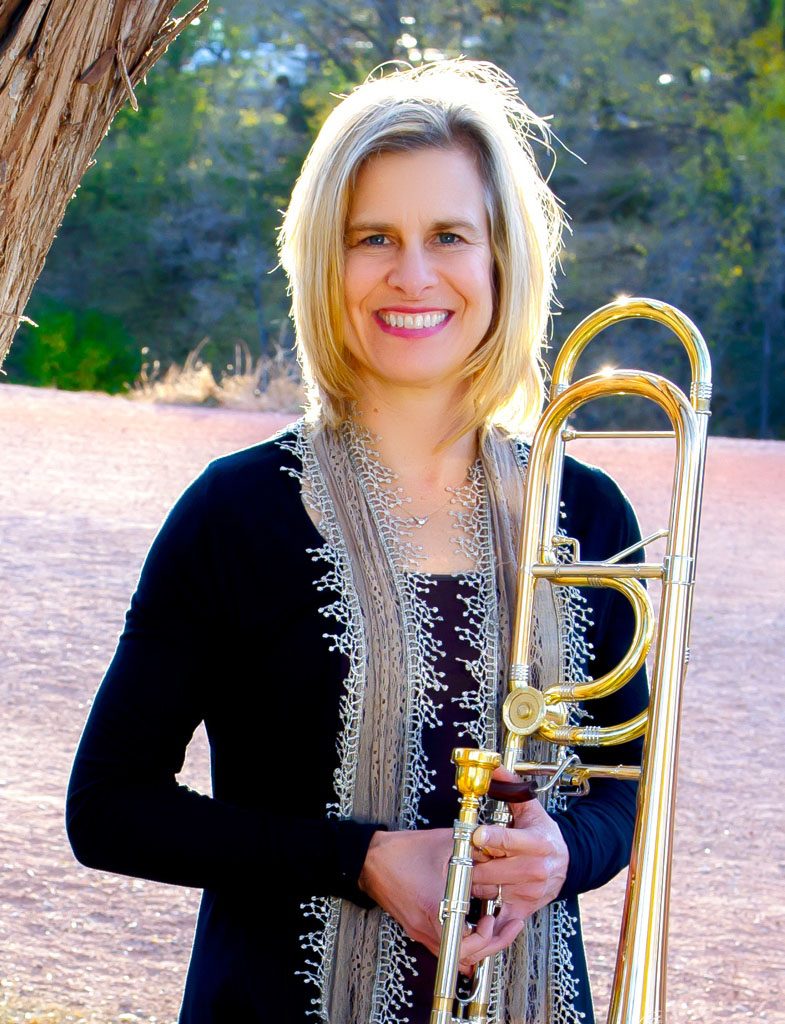 Dr. Sondra Bell smiling with her trombone